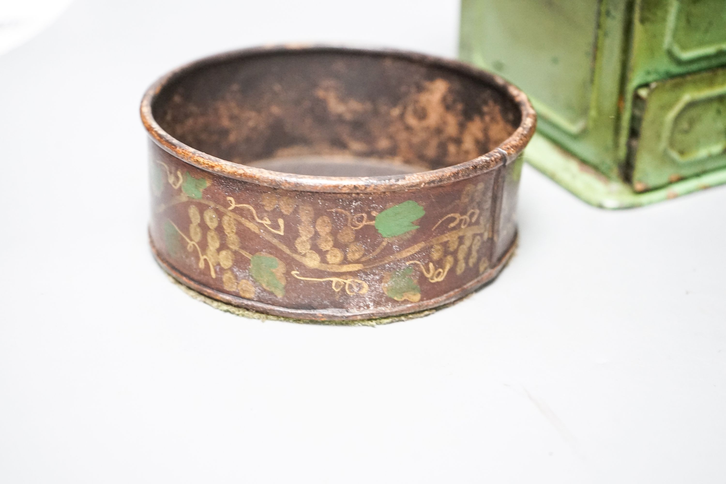 A pair of 19th century toleware coasters and a painted coffee grinder